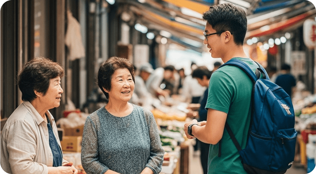 A young man converses with older shopkeepers at a Japanese open-air market.