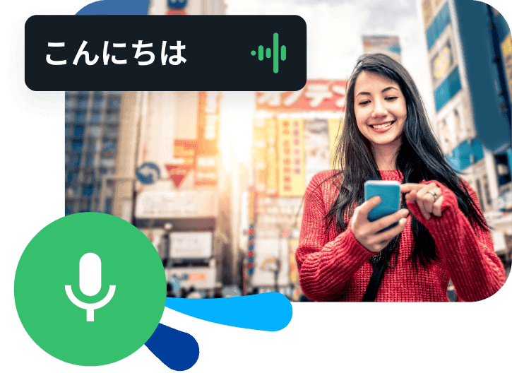 Woman practices speaking a new language into her phone while walking through Japanese skyscrapers.