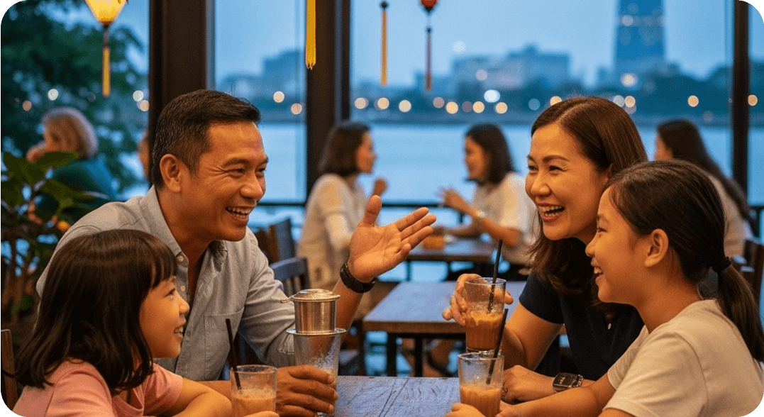 A family sitting together at a riverside café in Ho Chi Minh City, speaking Vietnamese and laughing over coffee and pastries.
