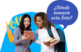 Two school age women using Rosetta Stone together, where one reads outloud "Donde tomaste esta foto?"
